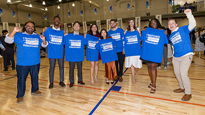 9 students show off their new blue #utswmatch t-shirts.