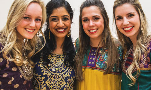 four students smiling