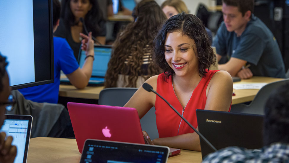 Student behind a laptop in the Team Based Learning Center