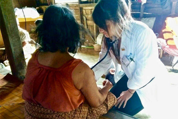 Caring for patients during a home visit in Surat Thani