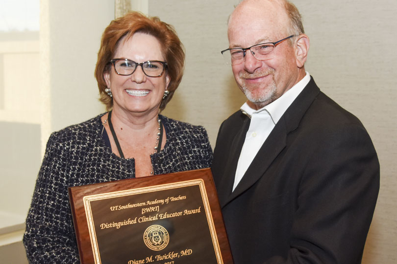Greg Fitz, M.D., gives Diane Twickler, M.D., an award for teaching excellence