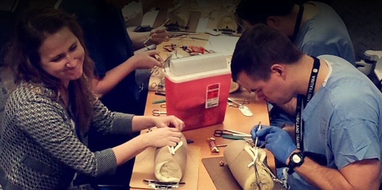 Two students learning to suture